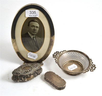 Lot 335 - An oval silver frame, small silver pierced dish, silver snuff box and a small silver box (4)