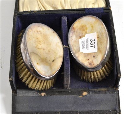 Lot 337 - Pair of silver backed brushes (cased)