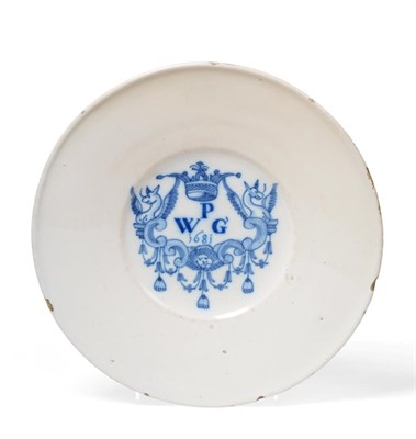 Lot 196 - A Delft Marriage Plate, dated 1681, the central well painted in blue with a crowned scroll...