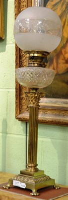 Lot 377 - A brass Corinthian column oil lamp with cut glass font