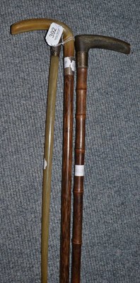 Lot 392 - Horn handled bamboo walking cane, a bull whip and another walking cane (3)