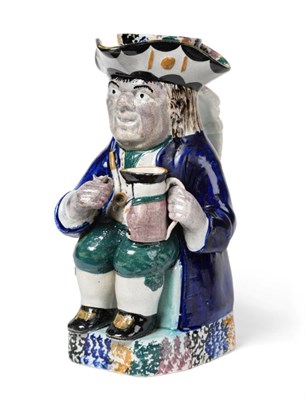 Lot 204 - A Pratt Type Pottery Toby Jug and Cover, circa 1800, of traditional form holding a pipe and...