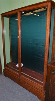 Lot 520 - A Victorian glazed oak display/gun cabinet stamped 'Holland & Sons'