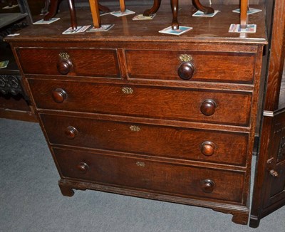 Lot 525 - A late George III oak and mahogany crossbanded five drawer chest