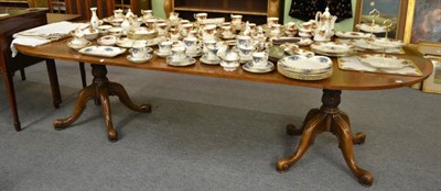 Lot 563 - A 20th century walnut dining table, raised on stop fluted carved supports, 270cm long