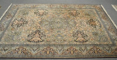 Lot 568 - A Kashmir silk rug, North West India, the faded salmon field of scrolling vines around a...