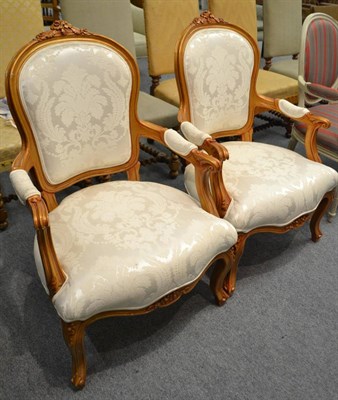 Lot 583 - A pair of white upholstered French style open armchairs