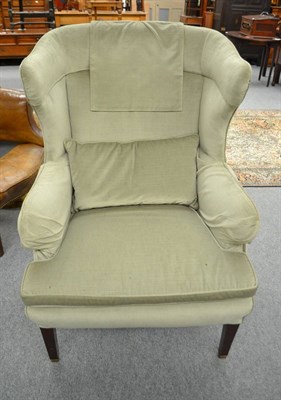 Lot 585 - A George III style wing back armchair re-covered in green velvet