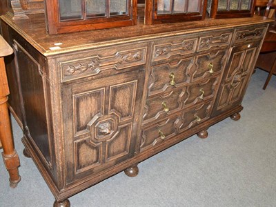 Lot 612 - A 1920s carved oak sideboard