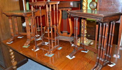 Lot 616 - A nest of three tables with leather tops, two rosewood nesting tables and a set of three...