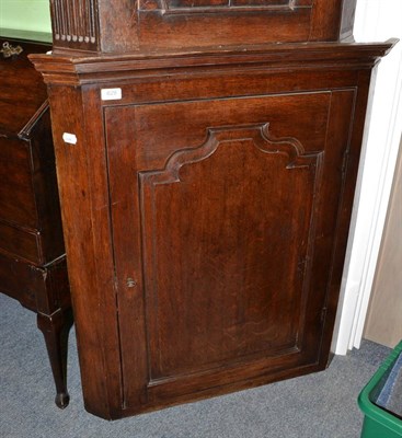 Lot 629 - A George III oak corner cupboard