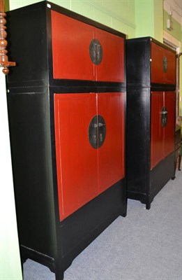 Lot 632 - A pair of Chinese ebonised and red painted wardrobes, 120cm wide