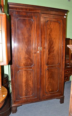 Lot 637 - A mahogany double door wardrobe with hanging space