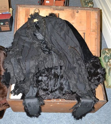 Lot 704 - Two Victorian capes, black silk skirt with cream ribbon trims, black under skirt, two bodices,...