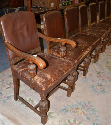 Lot 709 - A set of eight 1920s oak dining chairs with close nailed leather seats