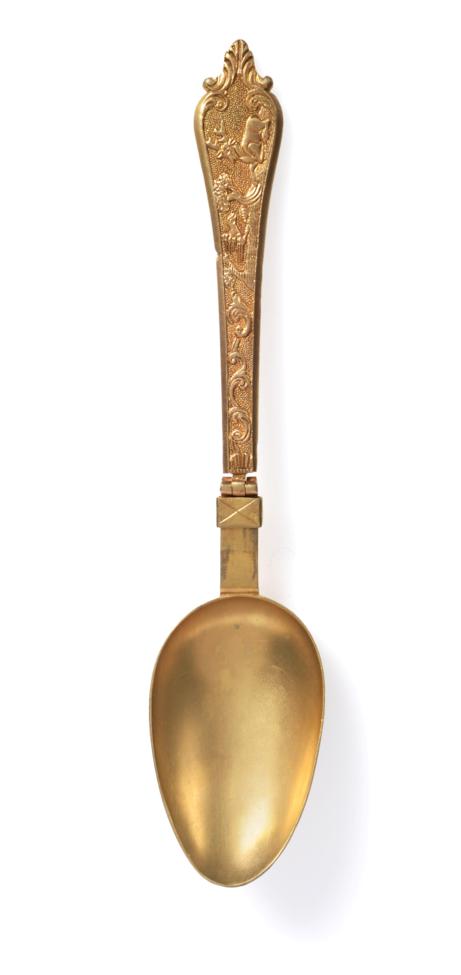 Lot 246 - A German Silver-Gilt Travelling Spoon, mid 18th century, the folding handle decorated with...