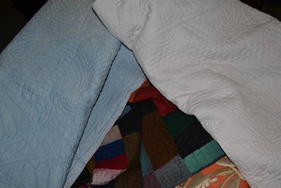 Lot 797 - Patchwork quilt made from wool and suiting fabrics, 150cm x 190cm; white quilt, 220cm x 230cm; blue