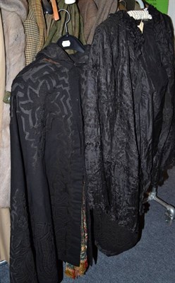 Lot 835 - Victorian black silk cut work cape, black wool cape with applique trims and an embroidered...