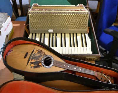 Lot 854 - A cased mandolin and a cased Hohner Verdi II piano accordion