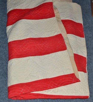 Lot 858 - Late 19th century patchwork quilt with red and white striped reverse