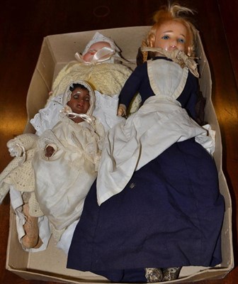 Lot 871 - Wax head doll with blue eyes, two baby dolls with bisque heads, another doll and doll's parasol