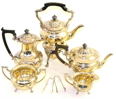 Lot 4 - A five-piece silver tea service, Sheffield 1908 and 1909 (teapots and bowls), 1923 (claw tongs) and