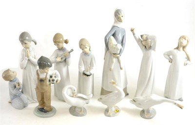 Lot 9 - A collection of Lladro figures of children, Lladro figures of swans and a Nao figure