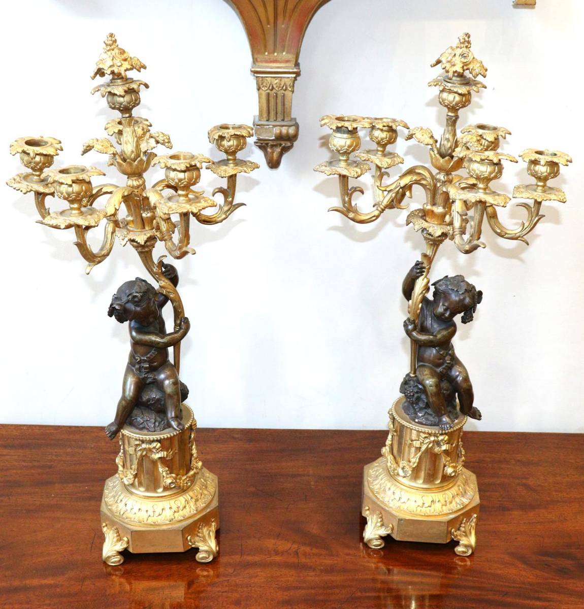 Lot 267 - A Pair of French Gilt and Patinated Bronze Six-Light Candelabra, 19th century, with foliate finials