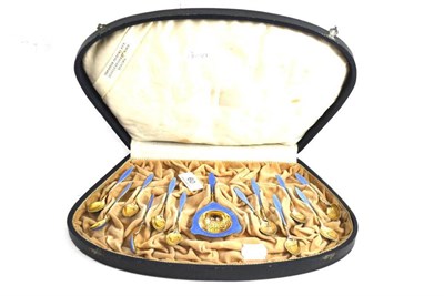Lot 60 - A set of twelve Continental silver gilt and enamel coffee spoons and strainer