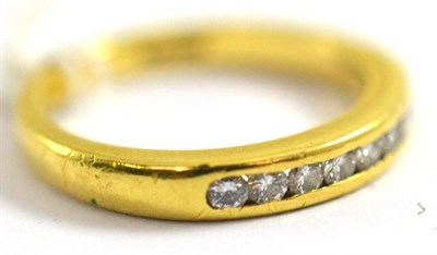 Lot 126 - An 18ct gold diamond channel set half hoop ring