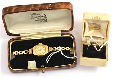 Lot 136 - A diamond three stone ring and a lady's 9ct gold wristwatch