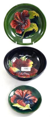 Lot 180 - A Walter Moorcroft Hibiscus pattern bowl, on a blue ground, impressed factory marks and green...