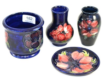 Lot 182 - Two Walter Moorcroft Anemone pattern vases, on blue grounds, impressed factory marks, 11cm...