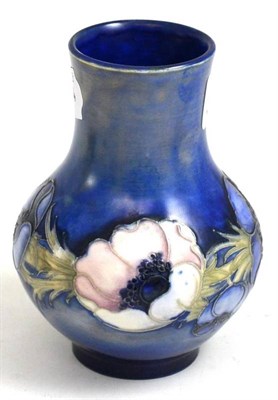 Lot 202 - A William Moorcroft Anemone pattern salt glazed vase, circa 1935, blue painted monogram,...