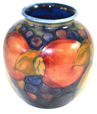 Lot 205 - A William Moorcroft Pomegranate pattern vase, on a blue ground, impressed factory marks and...