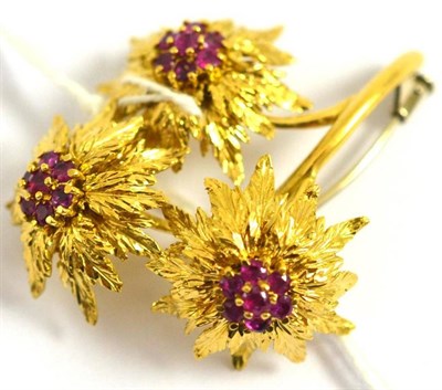 Lot 210 - An 18ct gold ruby triple flower brooch