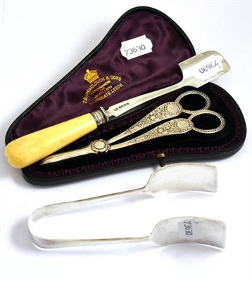 Lot 233 - A silver stilton scoop with ivory handle, a pair of cased silver grape scissors and silver...