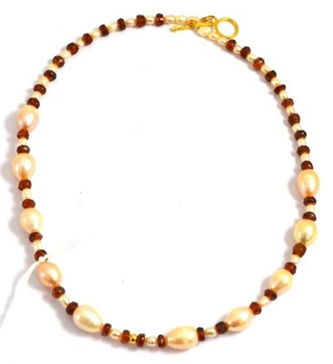 Lot 235 - A garnet and peach colour cultured pearl necklace