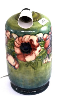 Lot 242 - A Walter Moorcroft Anemone pattern lamp, on a green/blue ground, impressed factory marks POTTER...