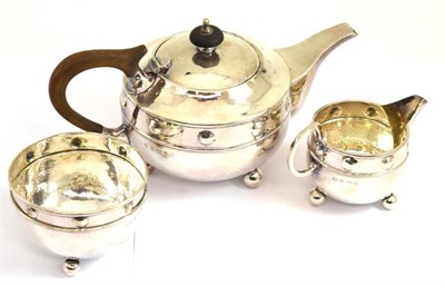 Lot 248 - An Arts & Crafts silver three piece tea service, Albert Edward Jones, Birmingham 1919,...