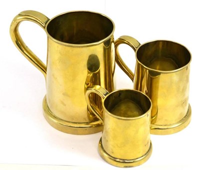 Lot 274 - Three 19th century graduated brass tankards