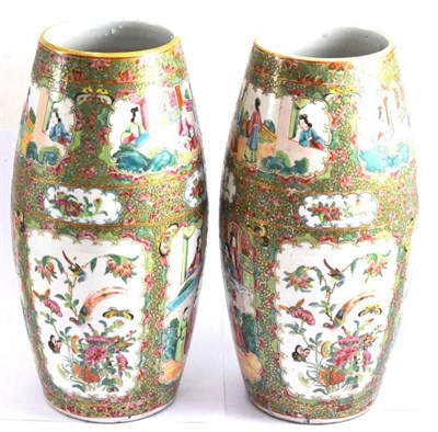 Lot 300 - A pair of Cantonese famille rose vases, mid 19th century, each of barrel form, decorated in typical