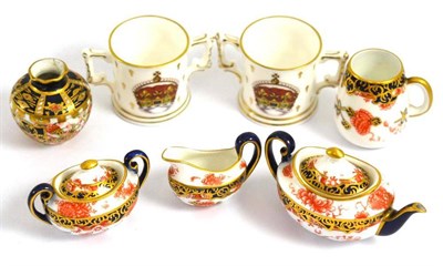 Lot 319 - * A Royal Crown Derby miniature three piece tea service, two loving cups, a mug and a vase