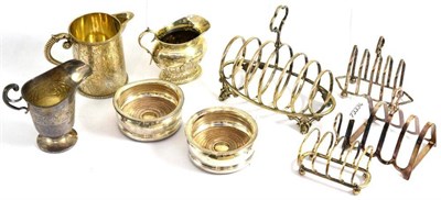 Lot 328 - A Victorian silver milk jug, two silver cream jugs, silver plated toast racks and a pair of...