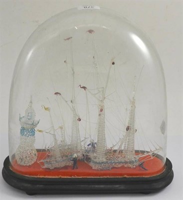 Lot 378 - * A Victorian glass frigger modelled as four ships near a lighthouse, under a glass dome