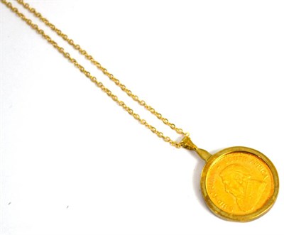 Lot 425 - A 1/10 Krugurand dated 1985, with attached pendant chain and a diamond set clasp