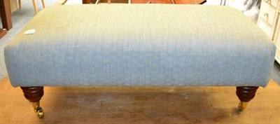 Lot 1042 - Blue upholstered footstool on castors