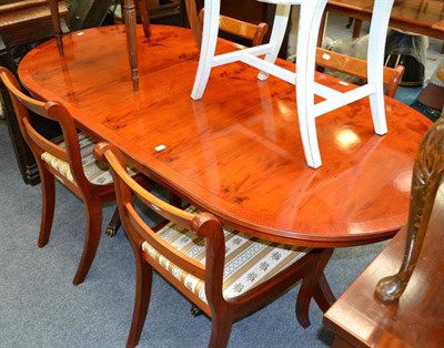 Lot 1058 - Yewwood dining table in the Regency style, four brass inlaid dining chairs, leaded glass panel...