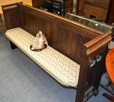 Lot 1061 - Dark oak church pew