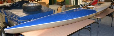 Lot 1069 - A kayak, paddle, splash guard and helmet, with roof rack bars and ties